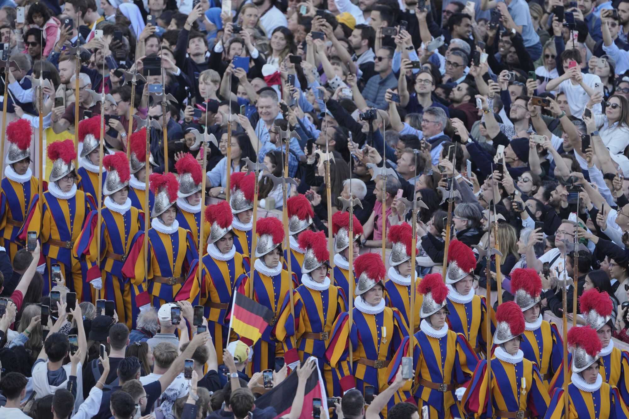 Swis guards march as white smoke billows from the chimney of the Sistine Chapel where 133 cardinals are gathering on the second day of the conclave to elect a successor to late Pope Francis, at the Vatican, Thursday, May 8, 2025 (AP Photo/Markus Schreiber)