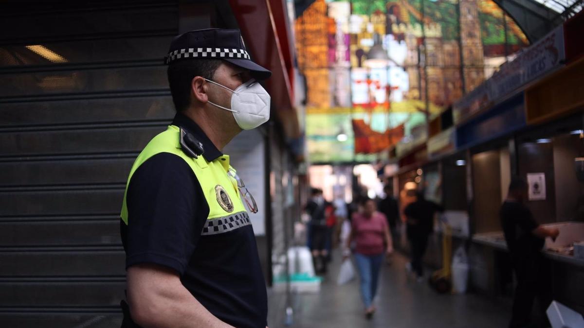 Un policía local controla el aforo en el Mercado de Atarazanas