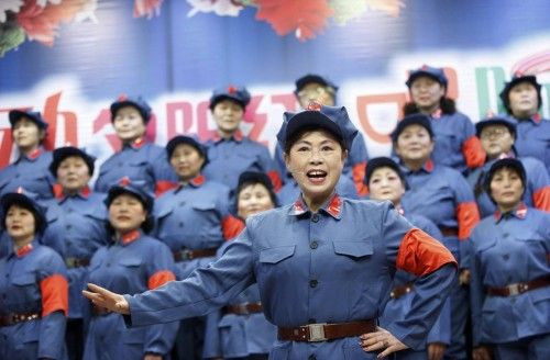 Retired workers dressed as red army soldiers sing revolutionary songs to mark 120th birth anniversary of Chairman Mao in Huaibei