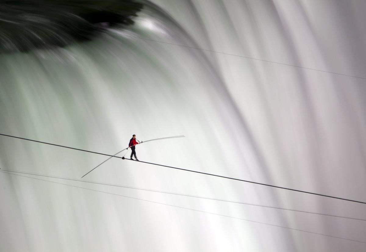 FOR USE AS DESIRED  YEAR END PHOTOS - FILE -In this June 15  2012 file photo  Nik Wallenda walks over Niagara Falls on a tightrope in Niagara Falls  Ontario  Wallenda finished his attempt to become the first person to walk on a tightrope 1 800 feet across the mist-fogged brink of roaring Niagara Falls  The seventh-generation member of the famed Flying Wallendas had long dreamed of pulling off the stunt  never before attempted   AP Photo The Canadian Press  Frank Gunn  File