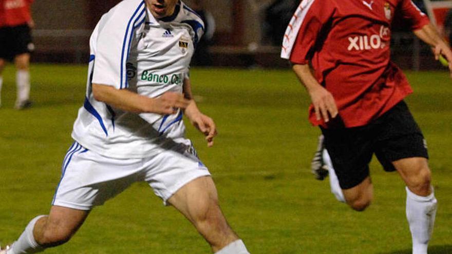Héctor se deja atrás el balón presionado por Cata, ex jugador del Montañeros. / fran martínez