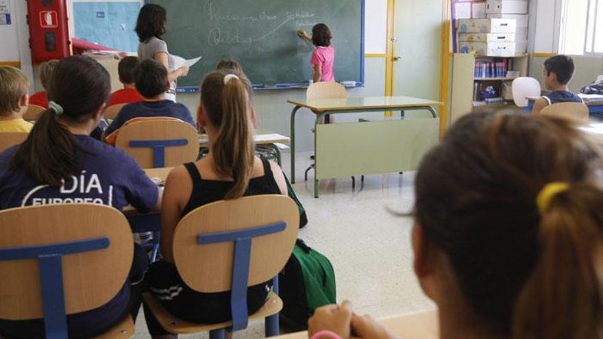 Niños de Primaria atienden en clase en el colegio.