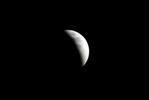 The moon is partially covered by the Earth's shadow during a total lunar eclipse in Port-of-Spain