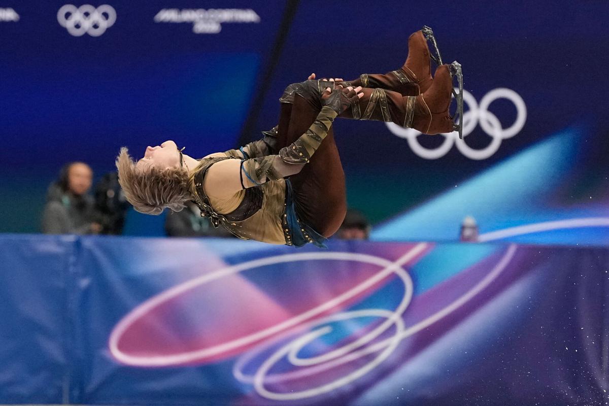 Ilia Malinin of the United States does a back flip while competing during the men's figure skating short program at the 2026 Winter Olympics, in Milan, Italy, Tuesday, Feb. 10, 2026. (AP Photo/Ashley Landis)