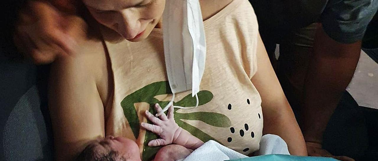 Lara sostiene a la pequeña Sira, acompañada de su marido, Gustavo, justo tras el parto en el vehículo.