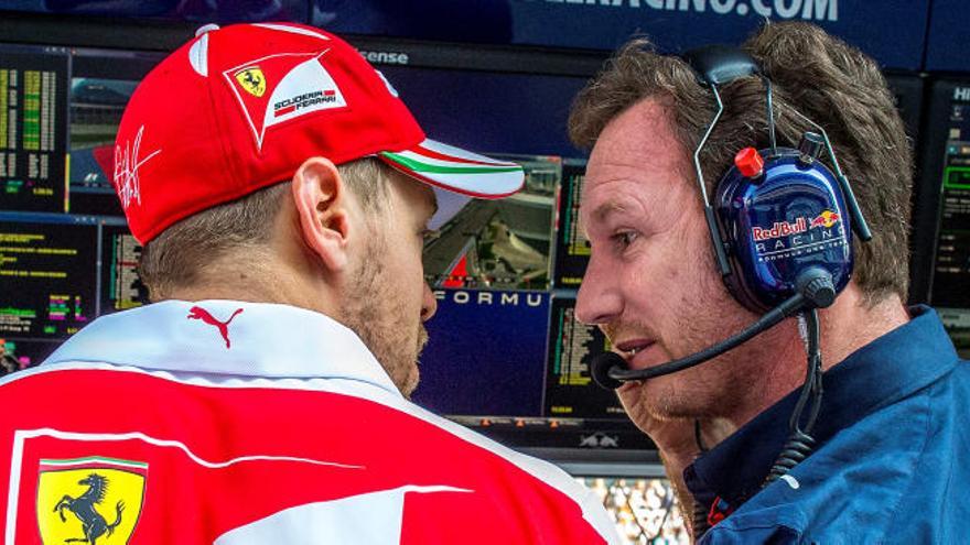 Christian Horner charla con Sebastian Vettel, expiloto de Red Bull.