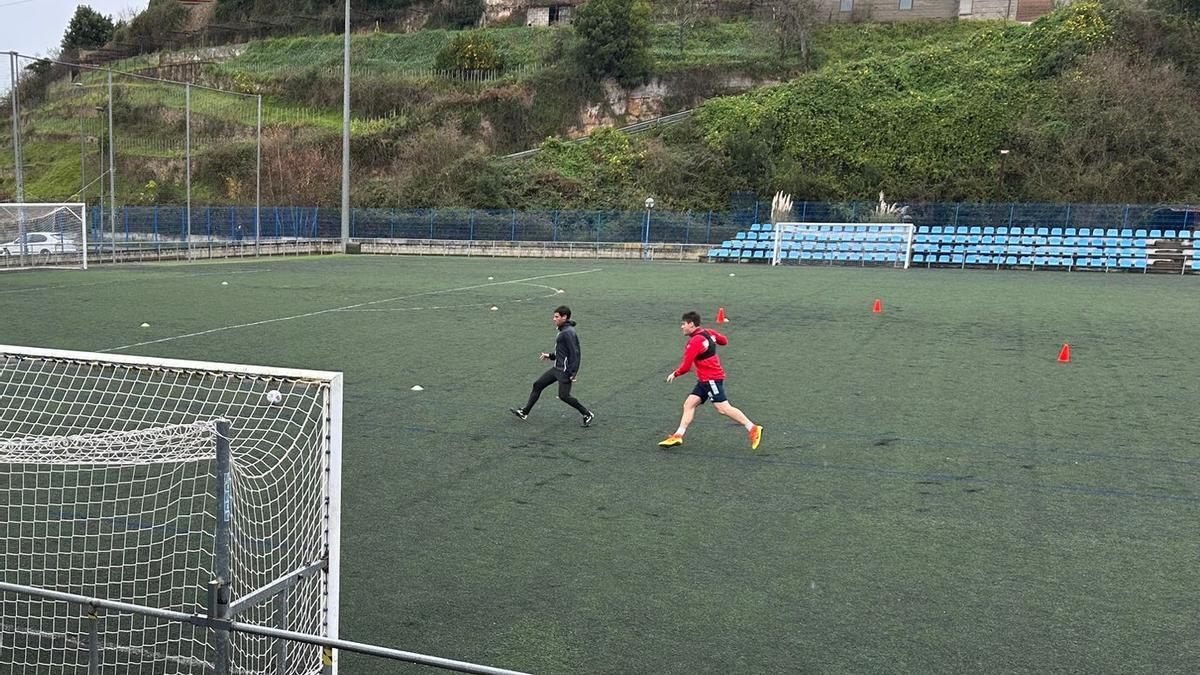 Meré, de rojo, junto al preparador Guillermo Rodríguez.