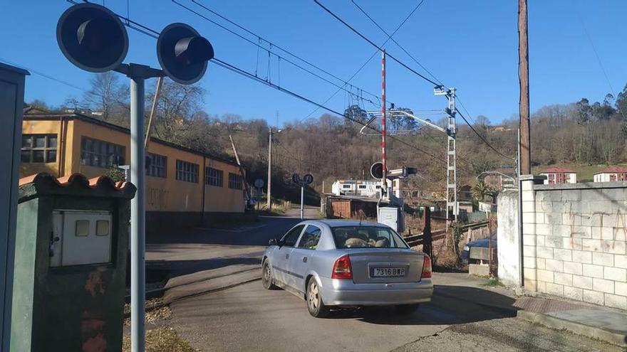 Un vehículo cruza el paso a nivel del centro de salud.