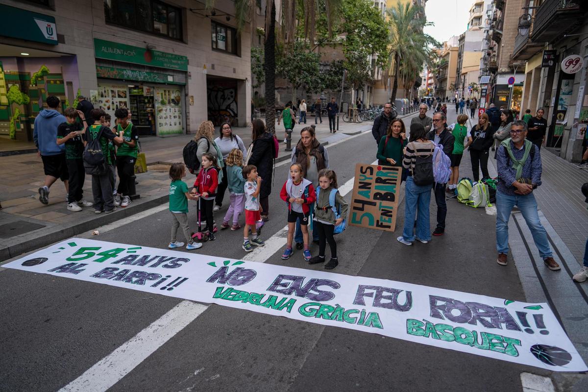 Participantes en la protesta de este jueves en Gran de Gràcia junto a una pancarta.