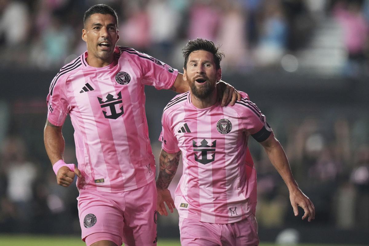 Inter Miami forward Lionel Messi, right, celebrates with Luis Suarez, left, after scoring a goal during the second half of an MLS soccer match against Nashville SC, Saturday, July 12, 2025, in Fort Lauderdale, Fla. (AP Photo/Lynne Sladky)