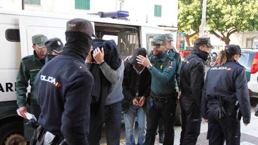 Los agentes detenidos por el robo llegan al juzgado custodiados por la Guardia Civil para prestar declaración.
