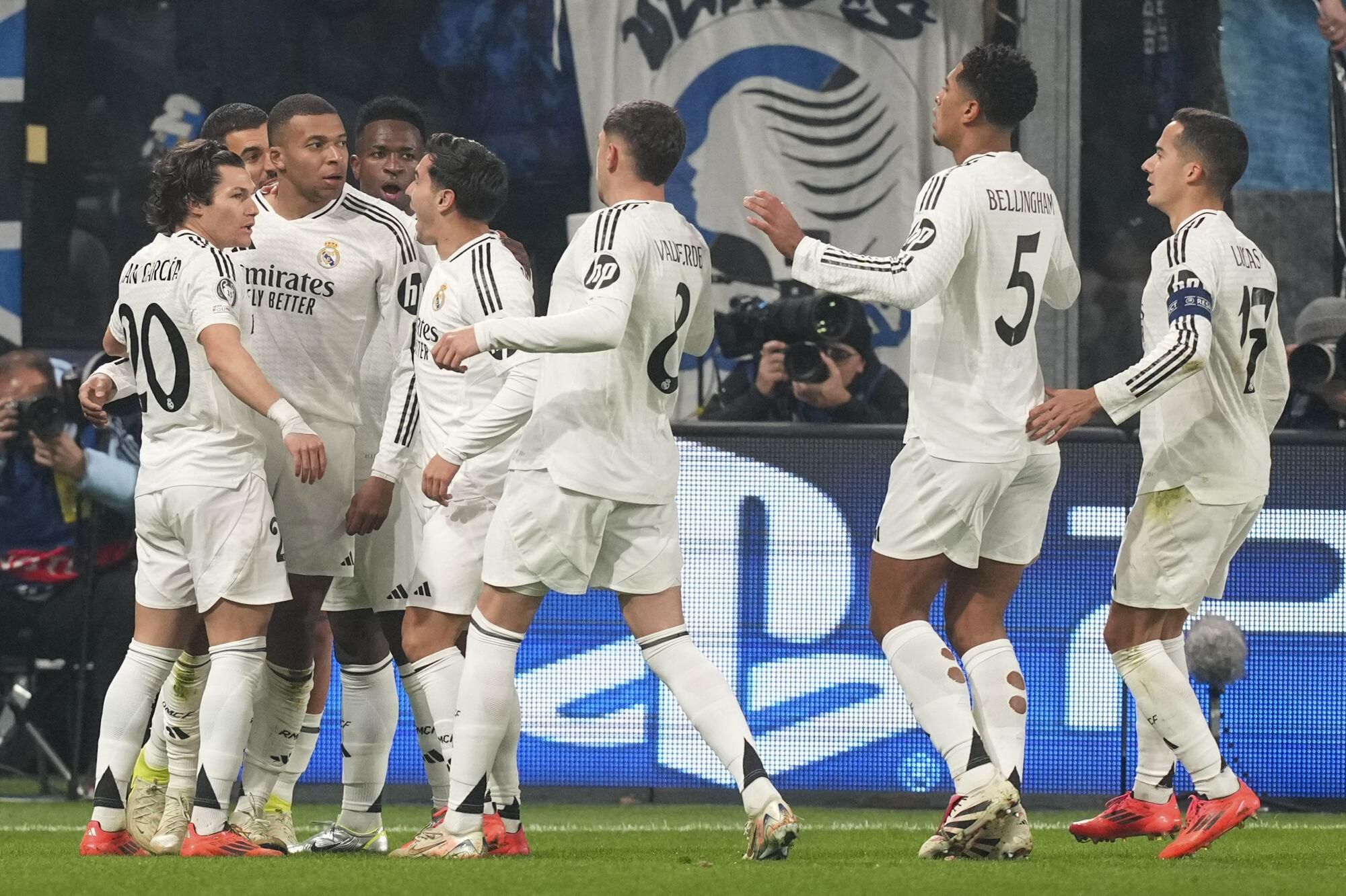 Real Madrid's Kylian Mbappe, second from left, celebrates with his teammates after he scored his side's first goal during the Champions League opening phase soccer match between Atalanta and Real Madrid at the Bergamo's stadium, in Bergamo, Italy, Tuesday, Dec. 10, 2024. (AP Photo/Antonio Calanni). EDITORIAL USE ONLY/ONLY ITALY AND SPAIN