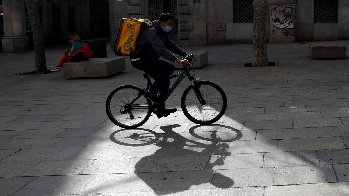 Glovo deliver rider passes through a pedestrian area in Barcelona  Spain  February 23  2021  Picture taken on February 23  2021  REUTERS  Albert Gea     TPX IMAGES OF THE DAY