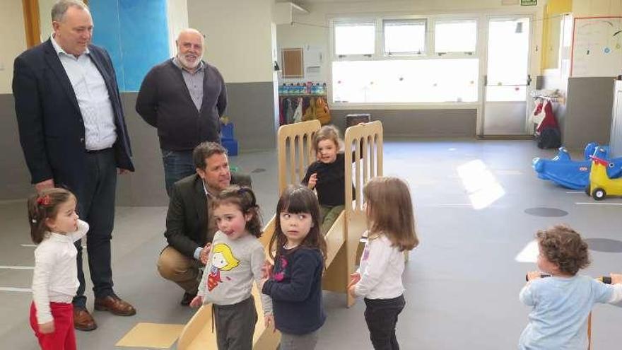 El gerente del Consorcio de Igualdade e Benestar (agachado) visita la escuela infantil de A Laracha.