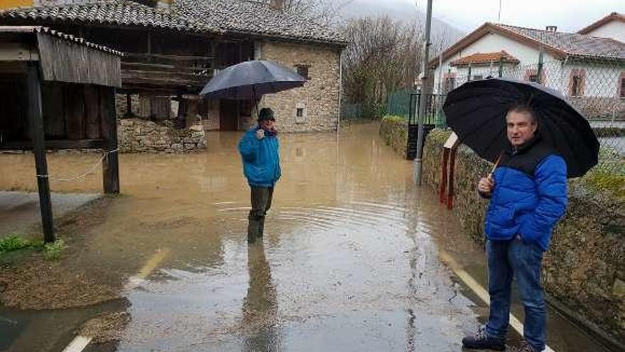 Los vecinos de Bueño Víctor González Tresguerres y Eugenio González, ayer en la zona inundada.