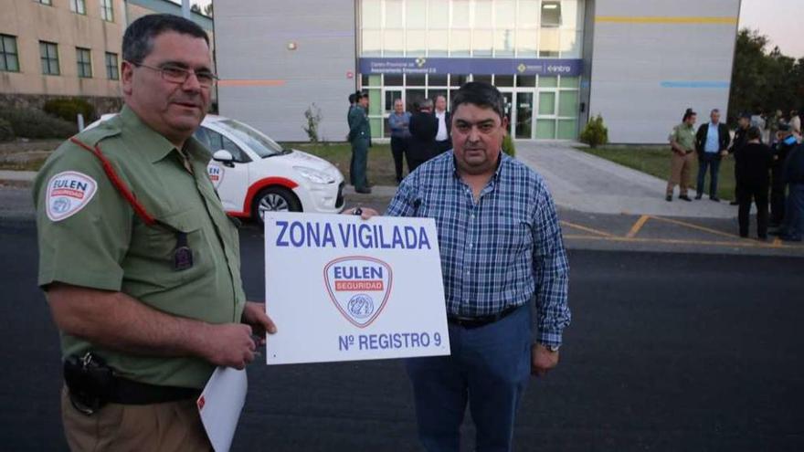 Un vigilante entrega una placa informativa a uno de los empresarios. // Bernabé/Gutier