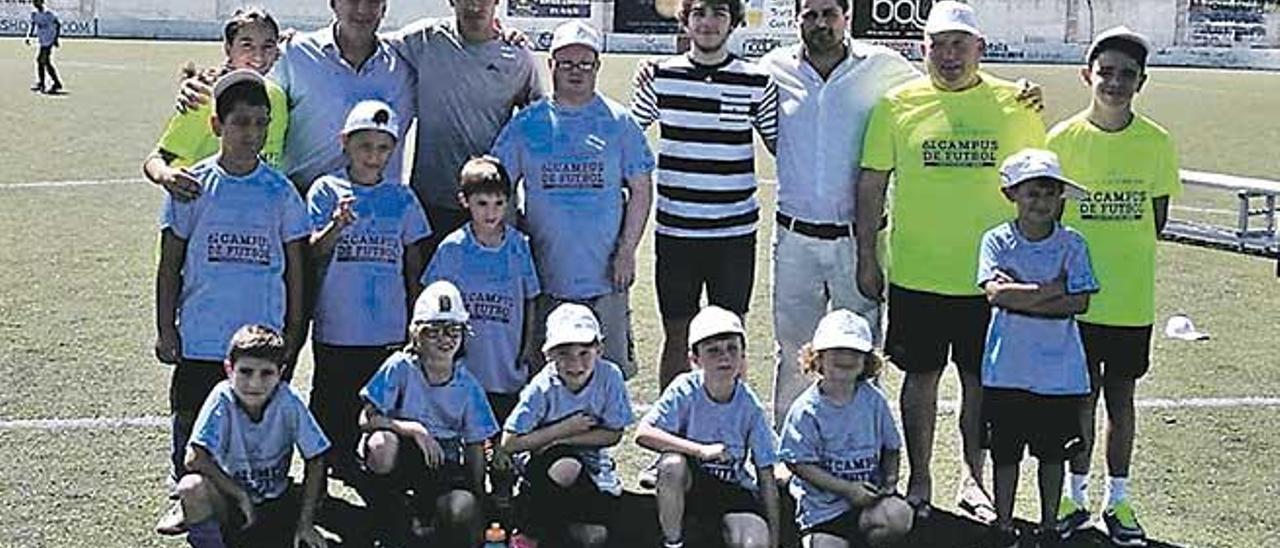 Los jugadores Campos y Florit, con varios niños del Campus Can Picafort.