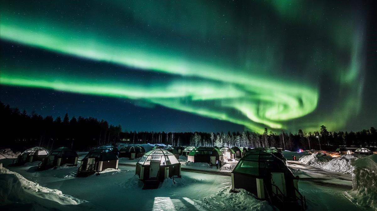 Una  Aurora Boreal se ve en el cielo sobre Arctic Snowhotel en Rovaniemi Finlandia