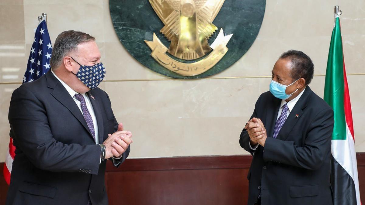 (FILES) In this file handout picture provided by Sudan s Prime Ministers office on August 25  2020  US Secretary of State Mike Pompeo (L) greets Sudanese Prime Minister Abdalla Hamdok (R) in Khartoum  - The United States on December 14  2020 formally removed Sudan s state sponsor of terrorism designation  27 years after putting the country on its blacklist  the US embassy in Khartoum announced   The congressional notification period of 45 days has lapsed and the Secretary of State has signed a notification stating rescission of Sudan s State Sponsor of Terrorism designation is effective as of today (December 14)  to be published in the Federal Register   the US embassy said on Facebook  (Photo by Handout   Office of Sudan s Prime Minister   AFP)       RESTRICTED TO EDITORIAL USE - MANDATORY CREDIT  AFP PHOTO   HO   SUDAN PRIME MINISTER OFFICE  - NO MARKETING - NO ADVERTISING CAMPAIGNS - DISTRIBUTED AS A SERVICE TO CLIENTS