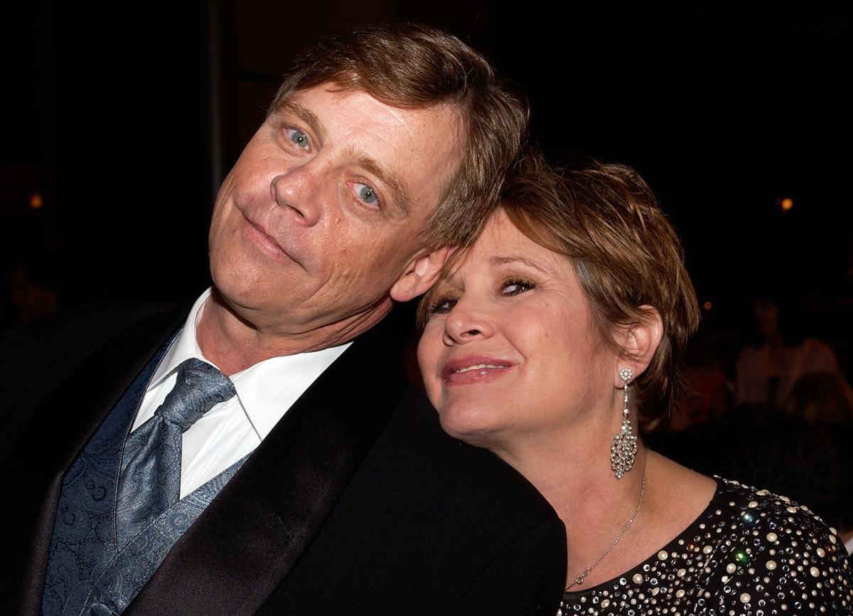 (FILES) This file photo taken on June 9, 2005 shows actors Mark Hamill and Carrie Fisher posing at the dinner during the 33rd AFI Life Achievement Award tribute to George Lucas at the Kodak Theatre  in Hollywood, California.