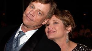 (FILES) This file photo taken on June 9, 2005 shows actors Mark Hamill and Carrie Fisher posing at the dinner during the 33rd AFI Life Achievement Award tribute to George Lucas at the Kodak Theatre  in Hollywood, California.