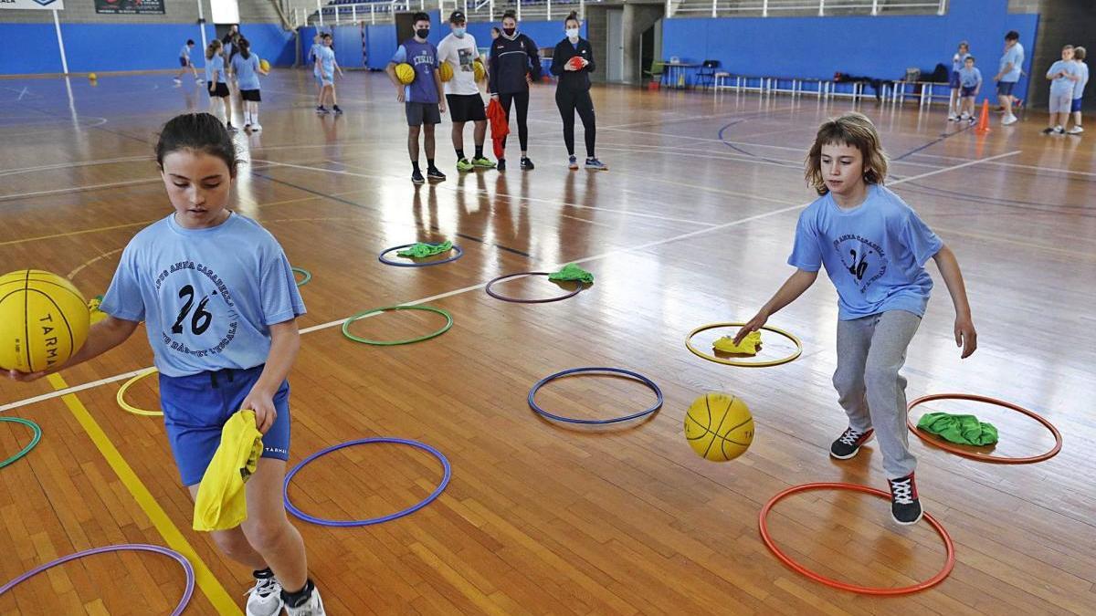 Dues joves jugadores fent exercicis ahir al pavelló de l&#039;Escala durant la primera jornada del Campus Anna Casabella.