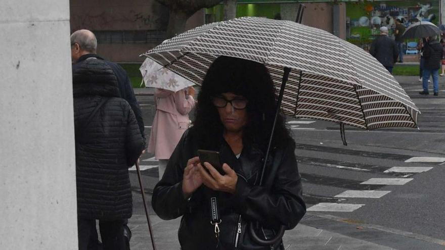 Una vecina observa el móvil en el simulacro de octubre. | | IAGO LÓPEZ