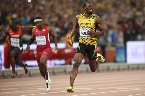 Usain Bolt of Jamaica crosses the finish line to win the men's 4 x 100 metres relay final during the 15th IAAF World Championships at the National Stadium in Beijing