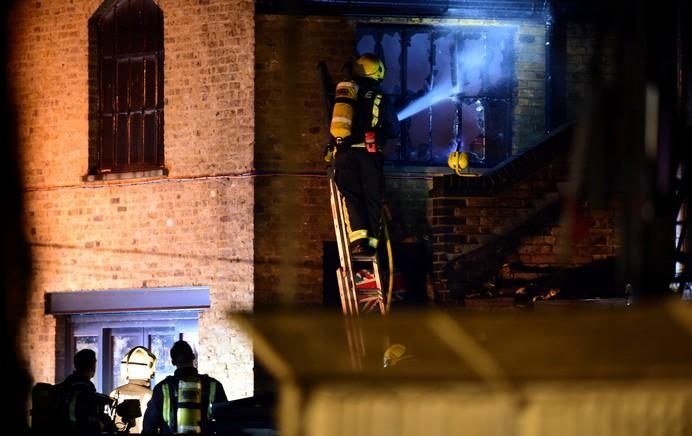 Firefighters tackle a fire at Camden Market in ...