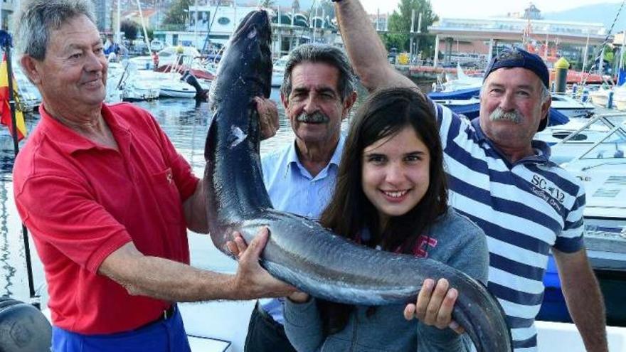 Antonio Castillo, Revilla, su hija, con el congrio, y Perfecto Alcántara.  // Gonzalo Núñez