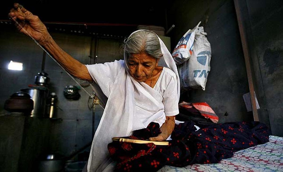 Pushpa Ben, de 80 anys d’edat i supervivent d’un terratrèmol a Gujarat, cus a l’interior de la seva botiga d’estany temporal, a la ciutat d’Anjar, a l’estat occidental de Gujarat (Índia).
