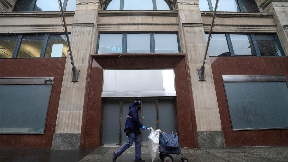 A postal employee walks past the Facebook office building during the coronavirus (COVID-19) pandemic in the Manhattan borough of New York City  New York  U S   December 9  2020  REUTERS Carlo Allegri