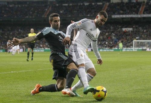 Real Madrid's Rodriguez battles for the ball with Celta Vigo's Costasduring their Spanish First Division soccer match at Santiago Bernabeu stadium in Madrid