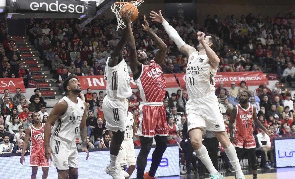 Devontae Cacok intenta anotar entre Garuba y Hezonja en el partido de la primera vuelta. | ISRAEL SÁNCHEZ