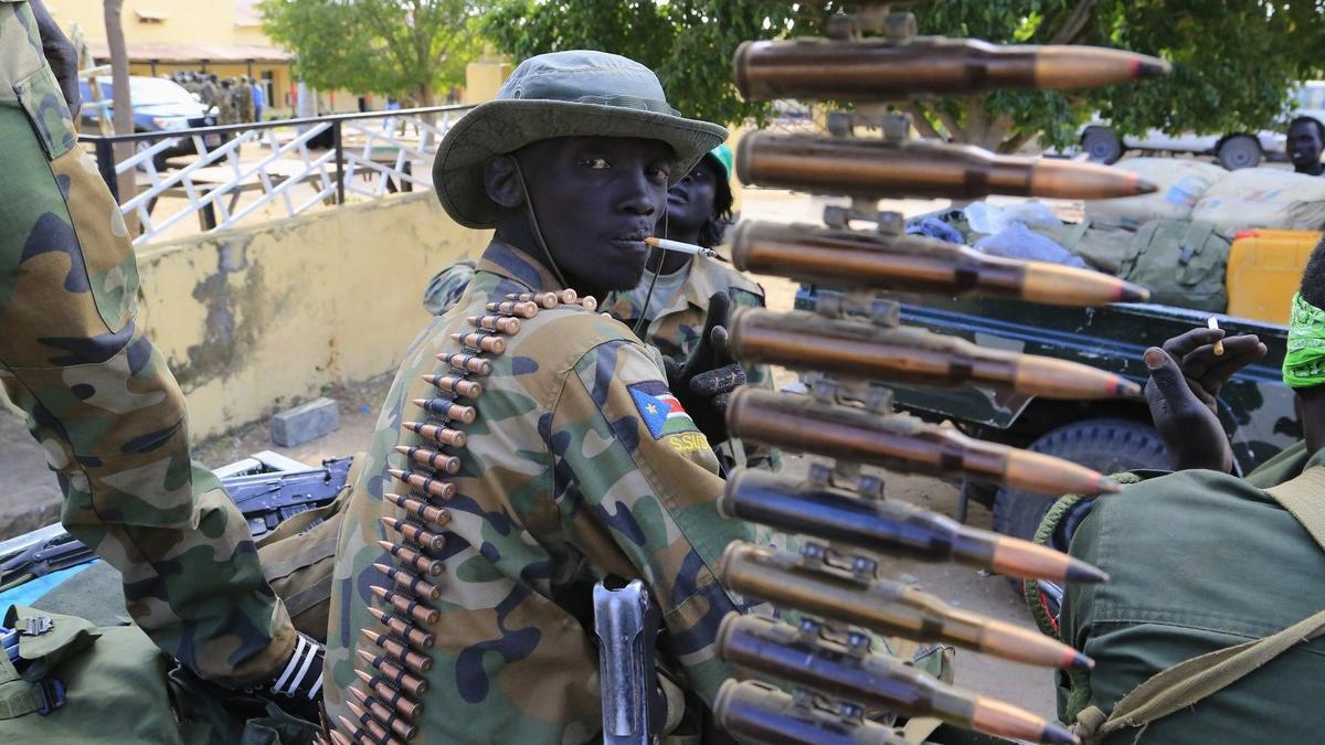 South Sudan army soldier stands next to a machine gun mounted on a truck in Malakal