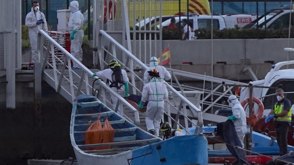 Red Cross workers transport the bodies of deceased immigrants in a canoe during the migration route to the Canary Islands Red Cross workers transport the bodies of deceased immigrants in a canoe during the migration route to the Canary Islands
