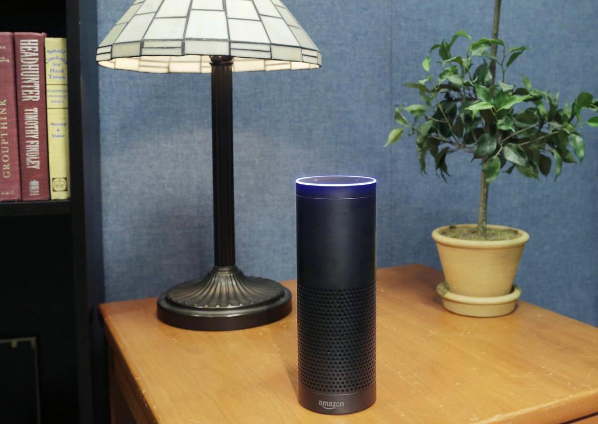 FILE - This July 29, 2015, file photo made in New York shows Amazon’s Echo, a digital assistant that continually listens for commands such as for a song, a sports score or the weather. Starting Thursday, March 17, 2016, Amazon’s voice assistant will tell you how well you slept and how much more exercise you need, at least if you have a Fitbit fitness tracker and an Alexa-compatible device, such as Amazon’s Echo speaker and Fire TV streaming devices. (AP Photo/Mark Lennihan, File)