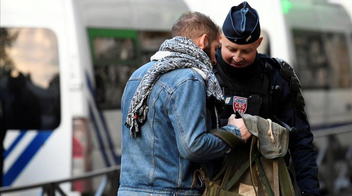 zentauroepp46177302 a french crs riot policeman checks the bag of a man near the181208093823
