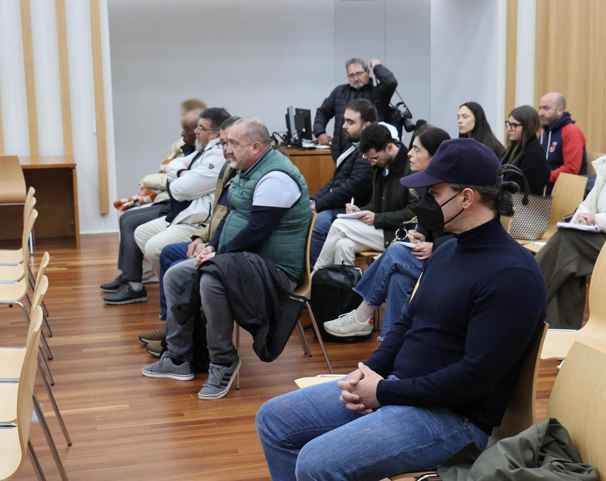El principal acusado, en primer plano con gorra y mascarilla, junto a los otros cuatro procesados (en el otro banco).