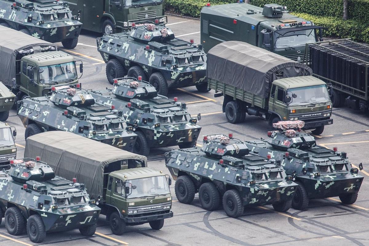 Military vehicles are parked on the grounds of the Shenzhen Bay Sports Center in Shenzhen, China August 15, 2019.  REUTERS/Thomas Peter