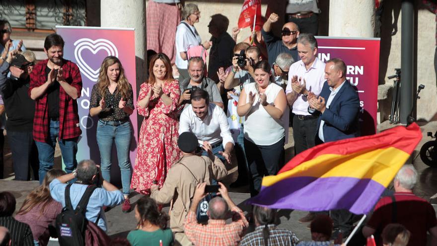 Los oradores de Unidas Podemos saludan a los asistentes al mitin que llenaron el claustro de la Nau.