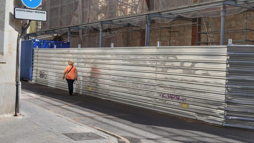 Una mujer camina por la estrecha zona de sombra en la plaza del Mercado. | ALBA PRIETO