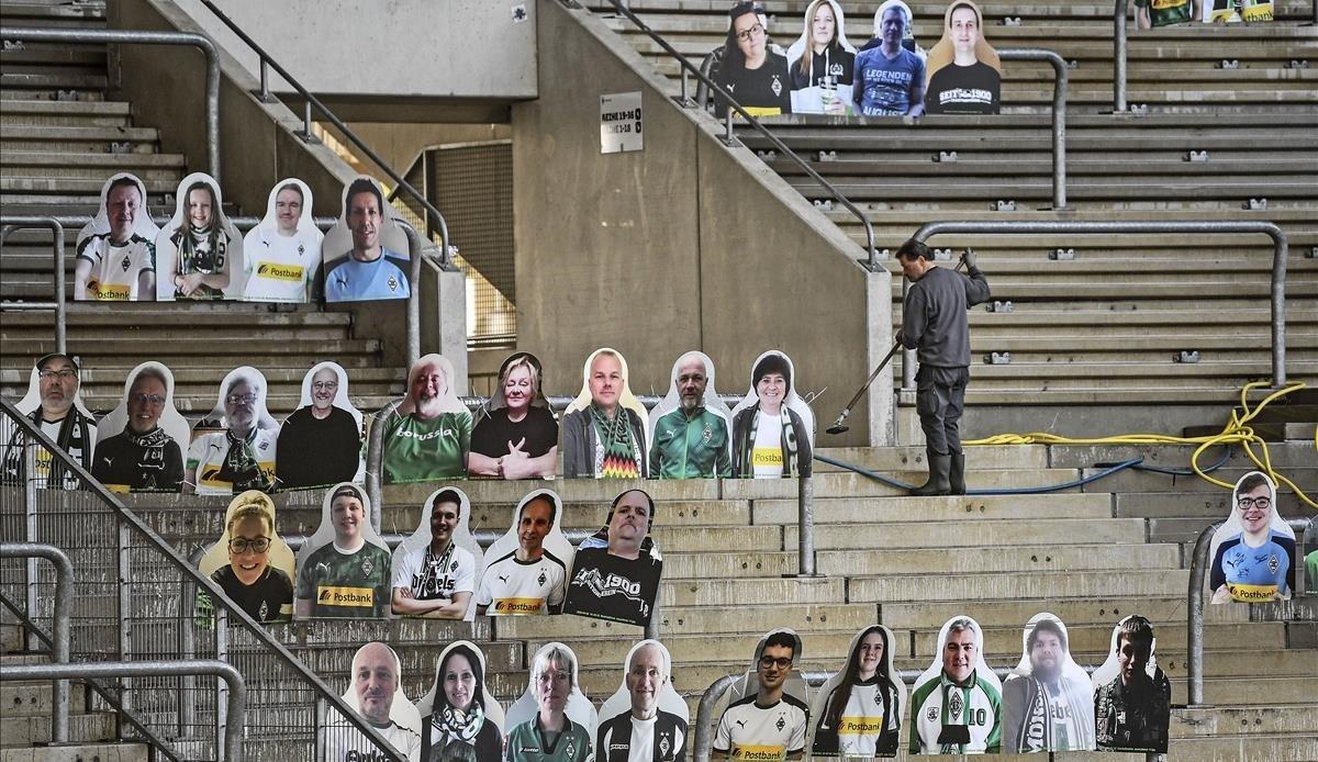 jdomenech53140056 a worker cleans the supporters tribune where portraits of fa200420102813