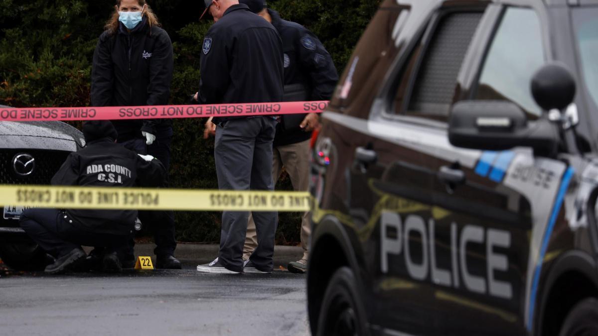 Law enforcement officers collect evidence near the scene of a shooting at the Boise Towne Square shopping mall in Boise, Idaho