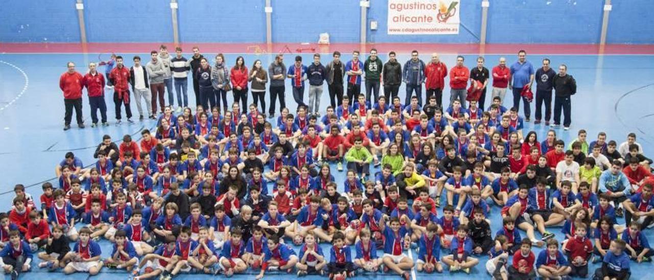 Decenas de alumnos, técnicos y monitores del Colegio San Agustín de Alicante posan con la camiseta tricolor de CD Agustinos el viernes en el pabellón del centro.