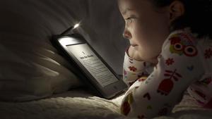 Una niña lee en un Kindle Fire Touch de Amazon. 