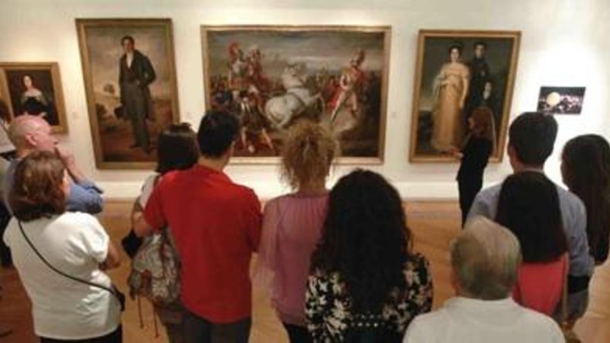 Personas mirando cuadros en el Museo de Bellas Artes de Murcia.