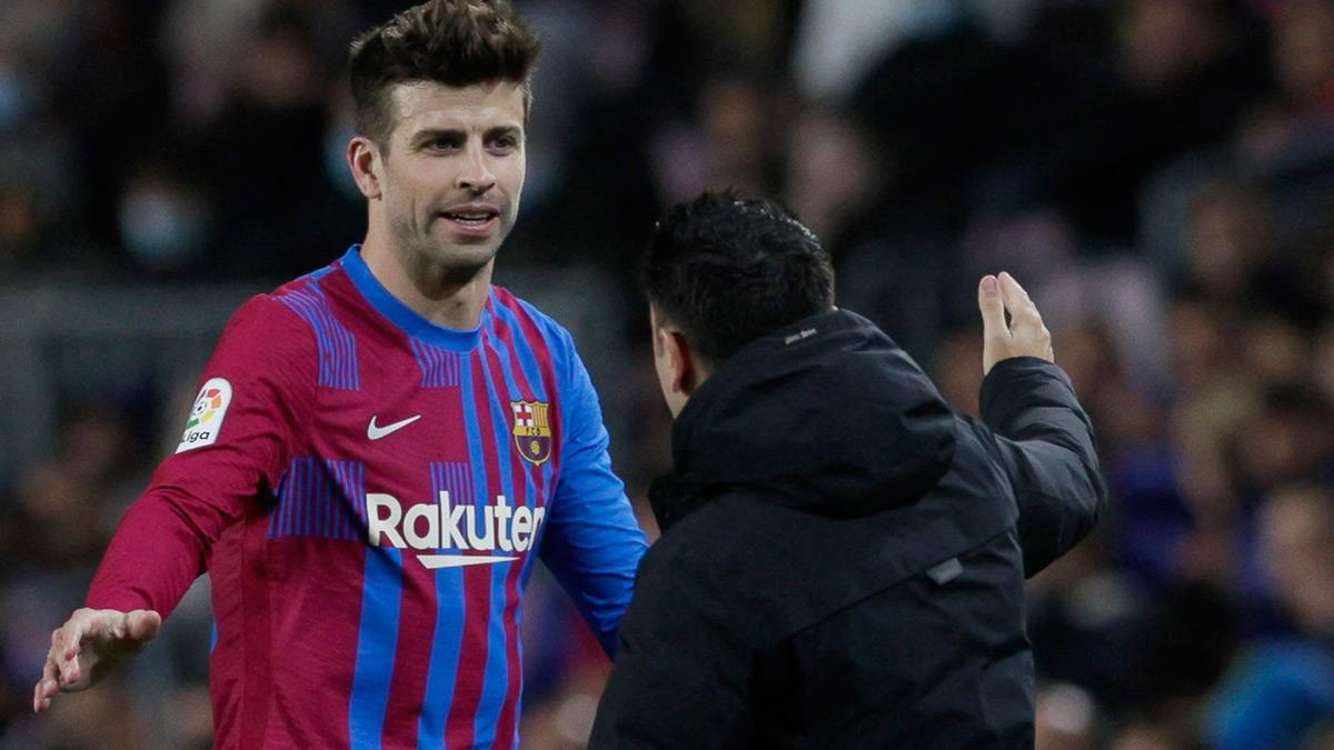 Xavi y Piqué, durante un partido