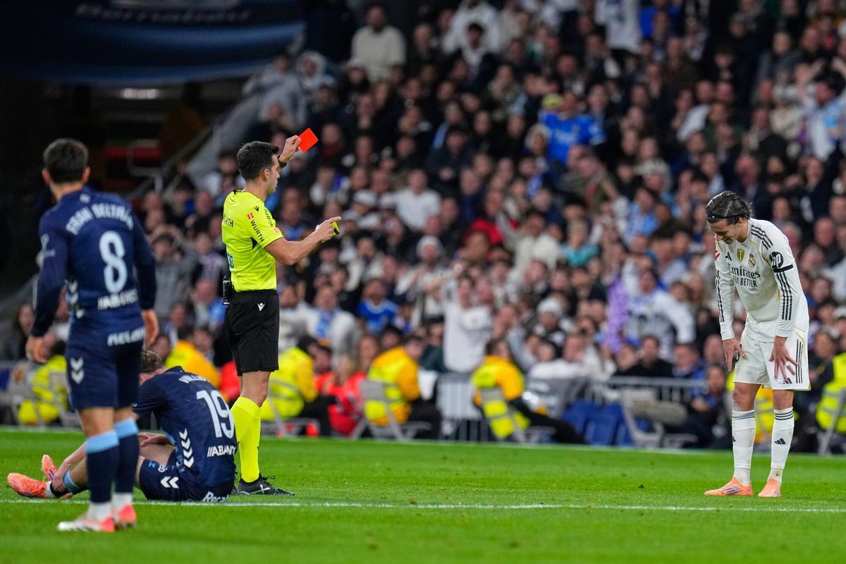 Real Madrids Alvaro Carreras gets a red card during the Spanish La Liga soccer match between Real Madrid and Celta Vigo in Madrid, Spain, Sunday, Dec. 7, 2025. (AP Photo/Manu Fernandez)