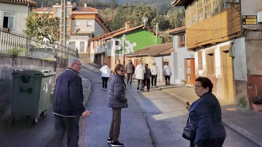 Vecinos pasean por la villa de Salas, durante los "Paseos saludables" de los miércoles